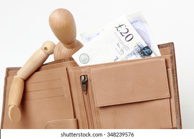 Cash Money UK Pounds In Brown Wallet And Figurine