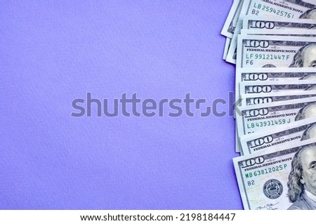 Cash on the table, purple background, money, us dollars, place for text, flat lay space for text