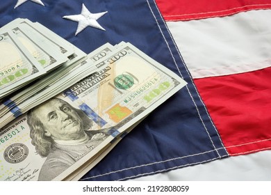 Cash On USA Flag As A Symbol Of Taxes, Inflation, The State Budget.