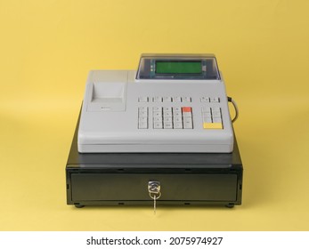 Cash Register Close-up On A Yellow Background. Retro Mechanism For Accounting For Sales Revenue.