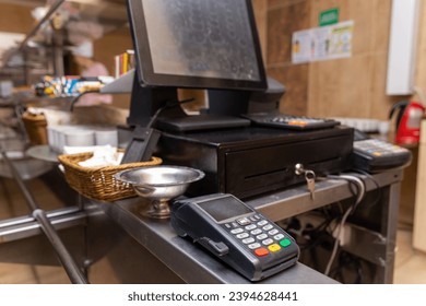 Cash register for paying for purchases in a cafe with a digital terminal. Seller workplace in the cafe. Payment trade through mobile and wireless NFC technology. - Shutterstock ID 2394628441