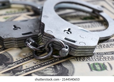 Cash In US Dollars, Real Handcuffs. The Concept Of Arrest, Corruption, Bail, Crime, Bribery Or Fraud