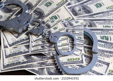 Cash In US Dollars, Real Handcuffs. The Concept Of Arrest, Corruption, Bail, Crime, Bribery Or Fraud