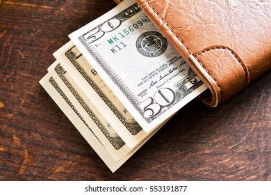 Cash In The Wallet On A Wooden Table