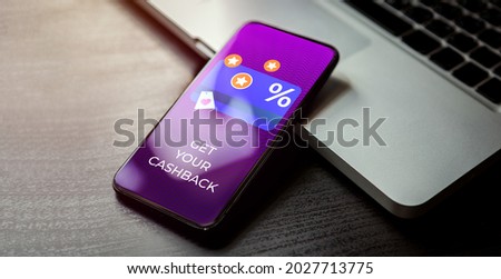 Cashback customer loyalty program concept. Smartphone with discount card with rewarding marketing points on the screen and text - get your cashback. Rewards and money refund service.