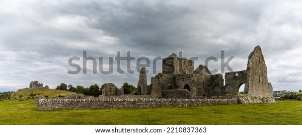 Cashel, Ireland - 17 August, 2022: panorama view\
of the Cistercian Hore Abbey ruins near the Rock of Cashel in\
County Tipperary of\
Ireland