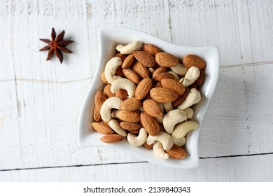 Cashew Nut And Almonds Or Badam Dry Fruits And Nuts In White Background Layout Kerala India. Protein Fiber Rich Food Snack Diet Mixed Nuts Layout Seeds, Food For Muscle Body Building.