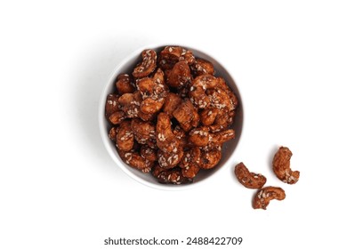 Cashew nut coated with palm sugar and sesame seeds. In a white bowl. Isolated on white background. Perfect for design element, product packaging, or any commercial purposes. 