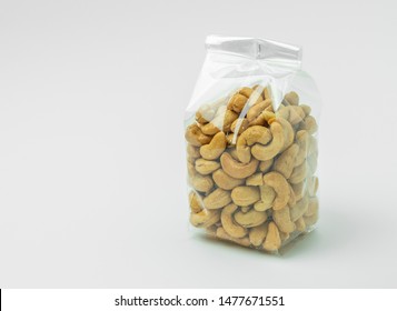 Cashew Nuts In Plastic Packaging On  White Background.