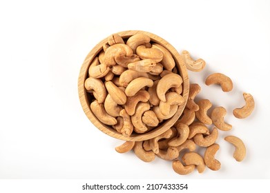 Cashew Nuts In Wooden Bowl Isolated On White Background. Top View
