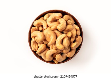 Cashew nuts in wooden bowl isolated on white background. Top view