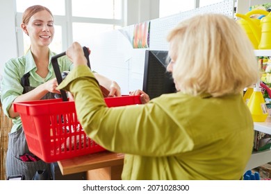 Cashier And Customer At The Checkout In The Hardware Store Or Garden Center When Paying