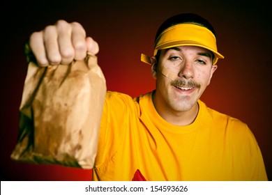 Cashier Serving A Greasy Paper Bad Of Unhealthy Junk Food