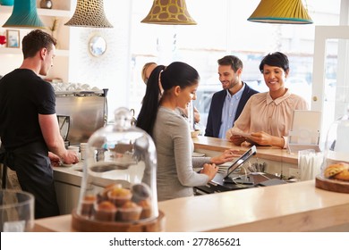 Cashier taking an order in cafe