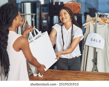 Cashier, women or customer with shopping bag in fashion shop or retail checkout for store purchase. Giving, buy and counter in boutique with designer or smile for clothing product, discount or sale - Powered by Shutterstock