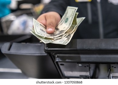 Cashier's Hand Giving Back Change To Customer