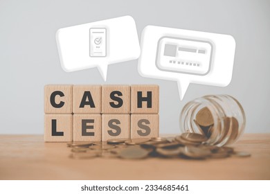 For cashless payments concept. CASH LESS word on wooden cube blocks with coins in jar and couple white speech bubble with mobile and credit card icon