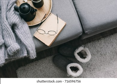 Cashmere Sweater, Reading And Serving Tray On Gray Sofa. Warm Weekend At Home. Detail Of Cozy Winter Interior.