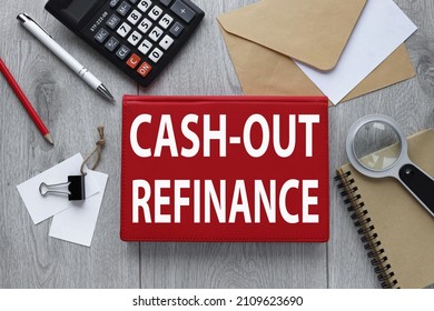 CASH-OUT REFINANCE red notepad on wood background with envelope and calculator - Shutterstock ID 2109623690