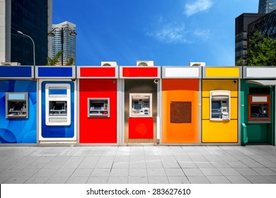 Cashpoint with colorful bankomats in the modern city