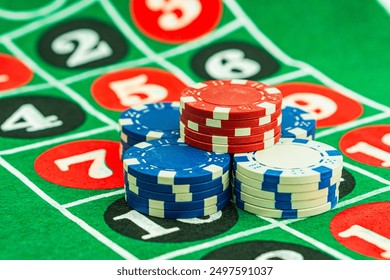 Casino background. Roulette table Chips. Casino theme. High contrast image of casino roulette, poker game, dice game, poker chips on a gaming table.