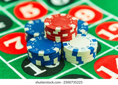 Casino background. Roulette table Chips. Casino theme. High contrast image of casino roulette, poker game, dice game, poker chips on a gaming table.