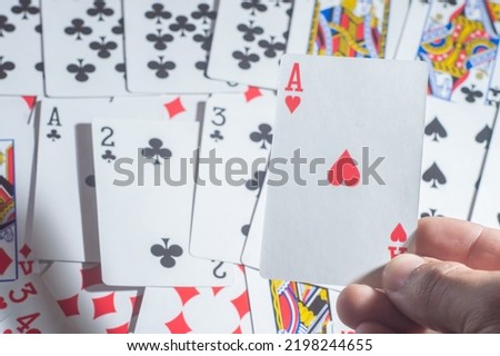 Casino cards poker blackjack,hand holding poker chips with copy space and deck card background.