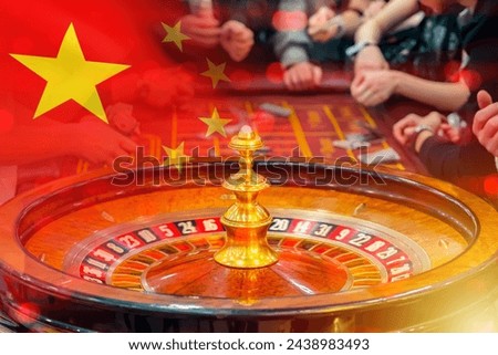 Casino in China. Roulette table. Flag people republic of China. Gambling in Chinese folk luck. People try luck at casino. Gambling industry in China. People hands around roulette table in casino 商業照片 © 