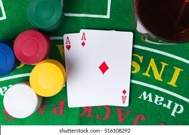 Casino Chips And Cards On Green Table. Two Aces. Whiskey Alcoholic Drink. Flat Lay Top View. Gambling Problems Abstract Concept.