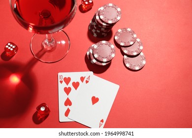 Casino Chips, Playing Cards, Dice And Cocktail On Red  Table, Flat Lay