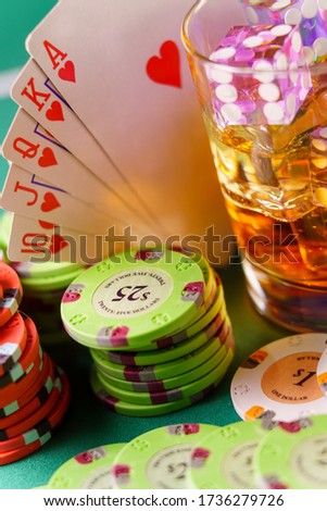 Casino concept - dice in cocktail glass on the gambling table