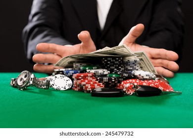 Casino, Gambling, People And Entertainment Concept - Close Up Of Poker Player With Chips, Money And Personal Stuff At Green Casino Table