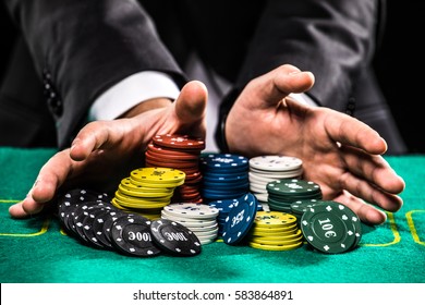 casino, gambling, poker, people and entertainment concept - close up of poker player with chips at green casino table - Shutterstock ID 583864891
