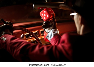 Casino Lucky Wish Concept. Casino Poker Player Talking To His Lucky Red Dice Inside The Classic Car.