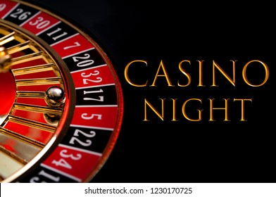 Casino Night Poster And Gambling On Games Of Chance Concept With The Ball In The Winning Number Seventeen On A Roulette Wheel Isolated On Black Background With Gold Text That Reads Casino Night