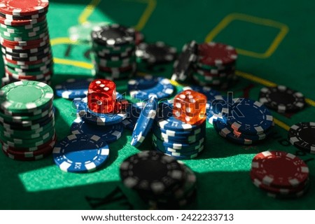 Casino poker chips on the green table.
