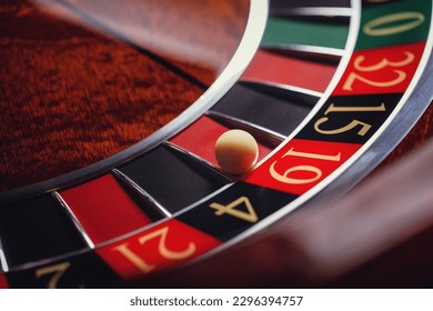 Casino roulette, close-up of a roulette ball, sectors red and black  - Powered by Shutterstock