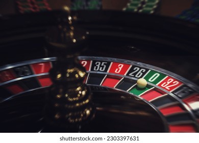 Casino roulette, close-up of a roulette ball, sectors red and black zero