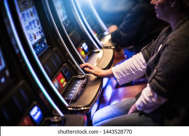 Casino Slot Gamblers. People Playing Video Slot Machines 