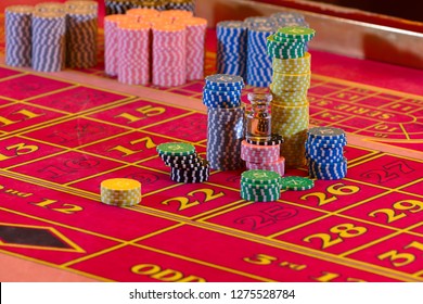 Casino table. American Roulette layout. Dolly is standing on stacks of playing chips.