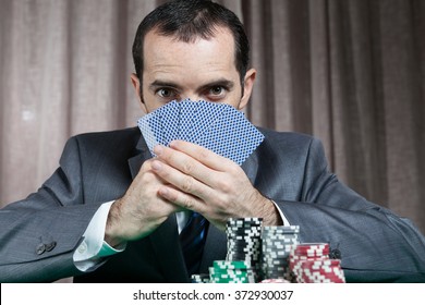 Casino Worker Holds Pocker Cards