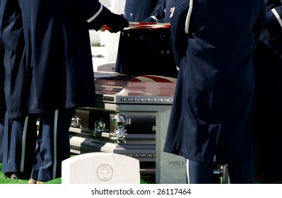 Casket At Military Funeral At Arlington National Cemetery With American Flag Reflected On Casket