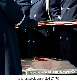 Casket At Military Funeral At Arlington National Cemetery With American Flag Reflected On Casket