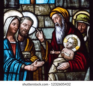 Casorate Primo, Italy. 2017/12/8. A stained glass window depicting Feast of the Presentation of Our Lord Jesus and the the Purification of the Blessed Virgin Mary in the church of San Vittore Martire.