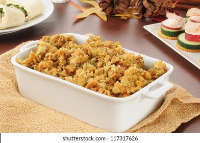 A Casserole Dish Of Turkey Stuffing With Canapes And Pinwheel Sandwiches