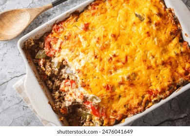 Casserole layers of ground beef, cheese, fresh vegetables and Jalapeno peppers baked closeup on the baking dish on the table. Horizontal top view from above
 - Powered by Shutterstock