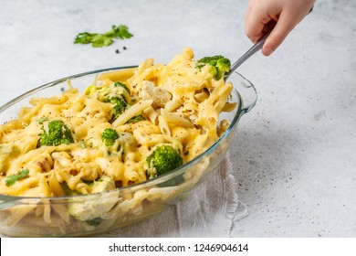 Casserole With Pasta, Chicken, Broccoli And Cheese Crust In A Glass Form, White Background.