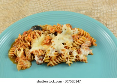 Casserole Serving Of Whole Wheat Rotini Pasta, Ground Turkey Meat, Cheese, Sliced Black Olives And Tomato Sauce On Plate