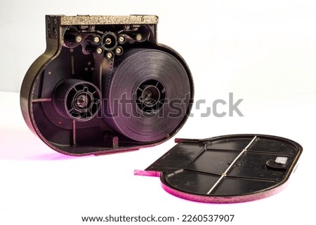 cassette to a 35 mm movie camera. open cassette with film in isolation.