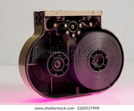 cassette to a 35 mm movie camera. open cassette with film in isolation.